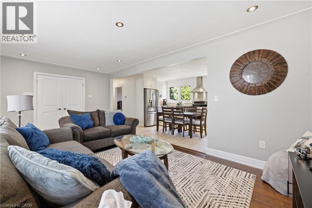 Living space featuring recessed lighting, wood-finish flooring, and light gray wall tones - 168 Nugent Drive, Hamilton, ON - Indoor Photo Showing Living Room