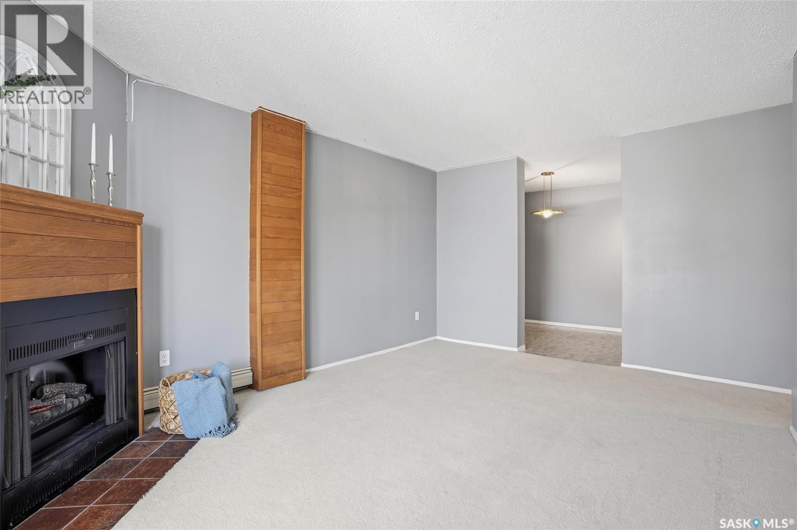 214 207C Tait Place, Saskatoon, SK - Indoor Photo Showing Living Room With Fireplace