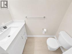 Bathroom featuring a white vanity with integrated sink, chrome faucet, and coordinating hardware -