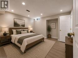 Spacious bedroom featuring wood-finish flooring, recessed lighting, a horizontal window, and a five-panel door with brass hardware -