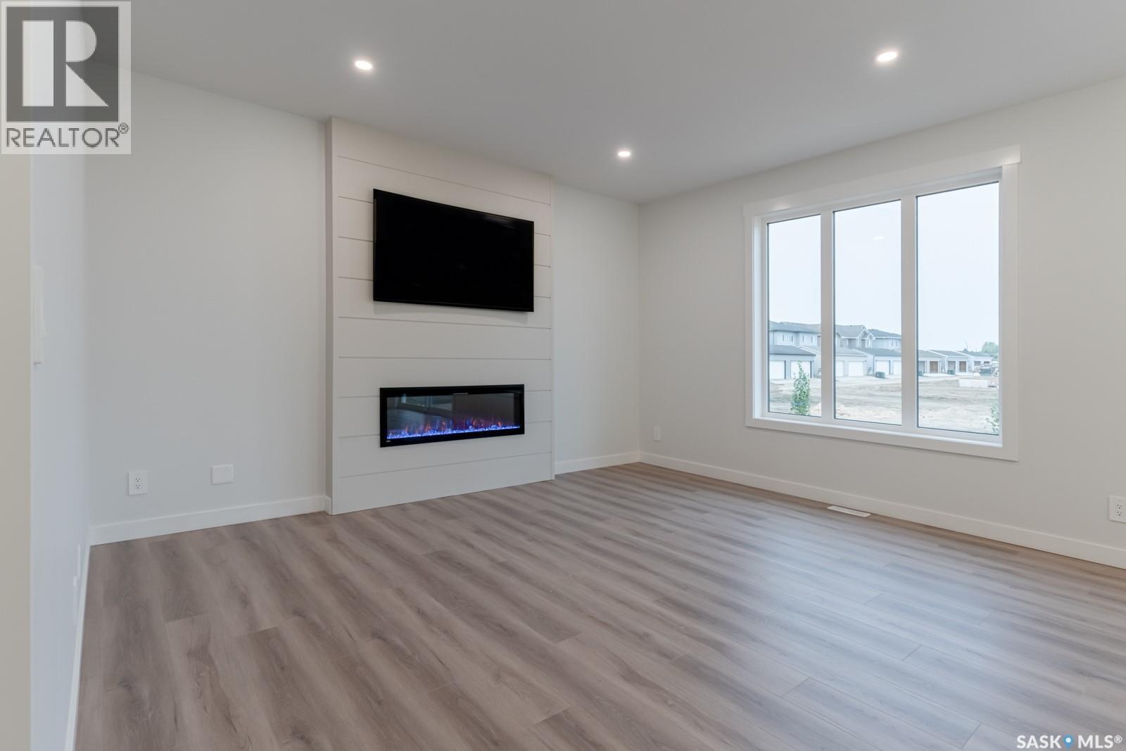 147 Traeger Common, Saskatoon, SK - Indoor Photo Showing Living Room With Fireplace
