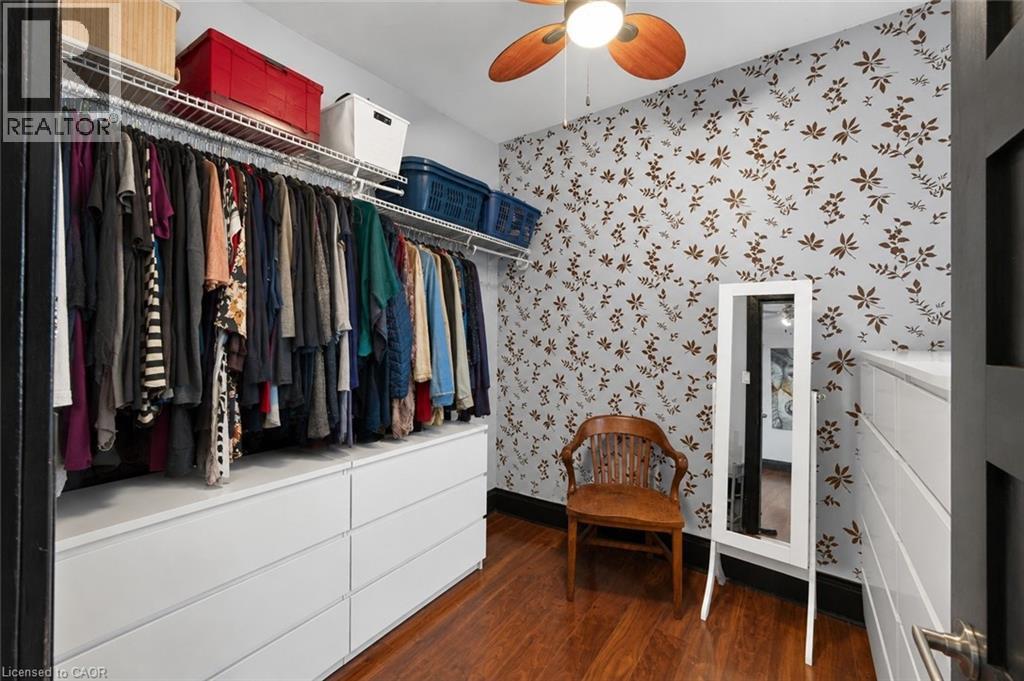 Custom closet featuring a built-in modular drawer system, overhead shelving, and hardwood flooring - 147 Strachan Street E, Hamilton, ON - Indoor Photo Showing Other Room