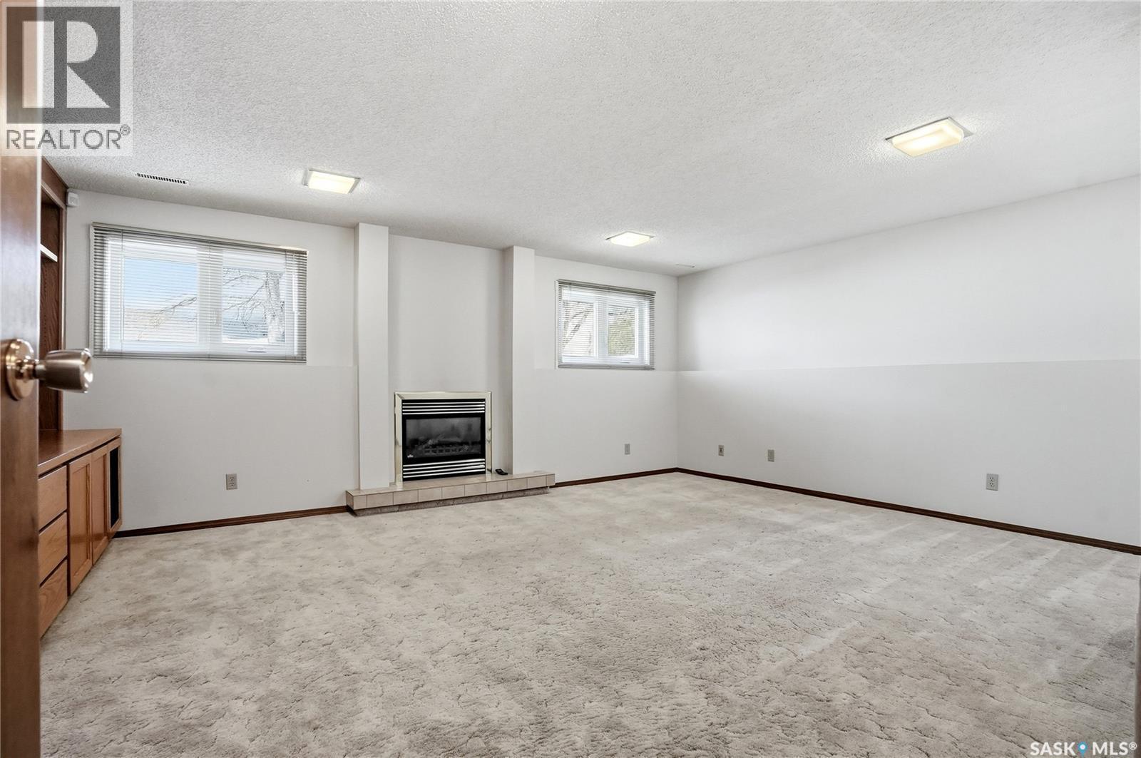227 Flavelle Crescent, Saskatoon, SK - Indoor Photo Showing Other Room With Fireplace