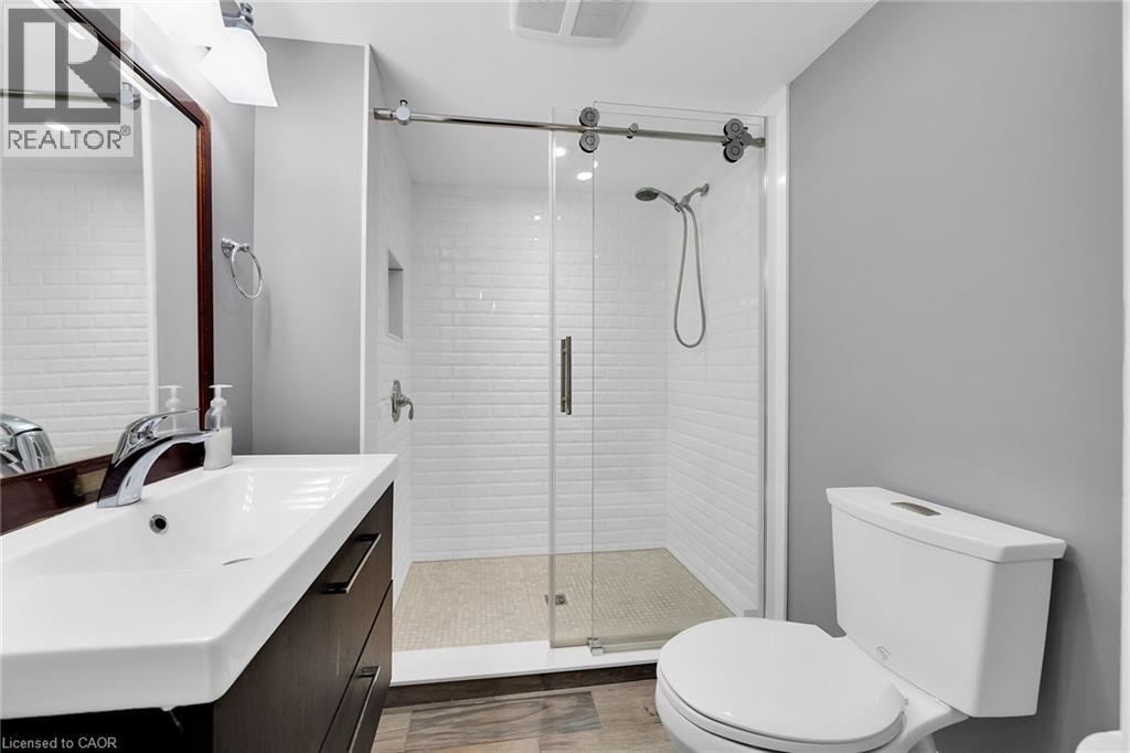 Full bathroom featuring vanity, a stall shower, dark wood-style floors, and recessed lighting - 404 Mountain Brow Boulevard E, Hamilton, ON - Indoor Photo Showing Bathroom