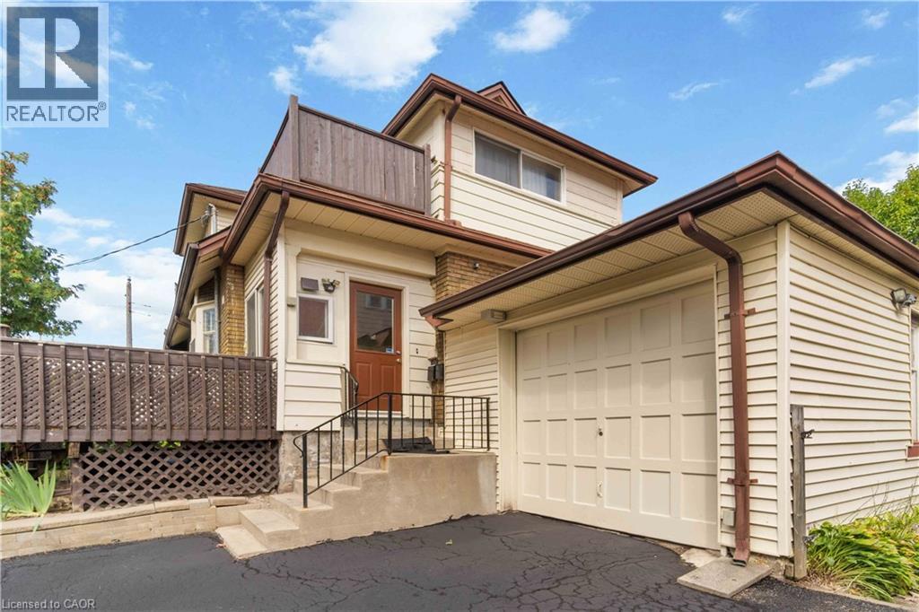 Cream-colored siding exterior with brown trim and gutters - 151 Louisa Street, Kitchener, ON - Outdoor