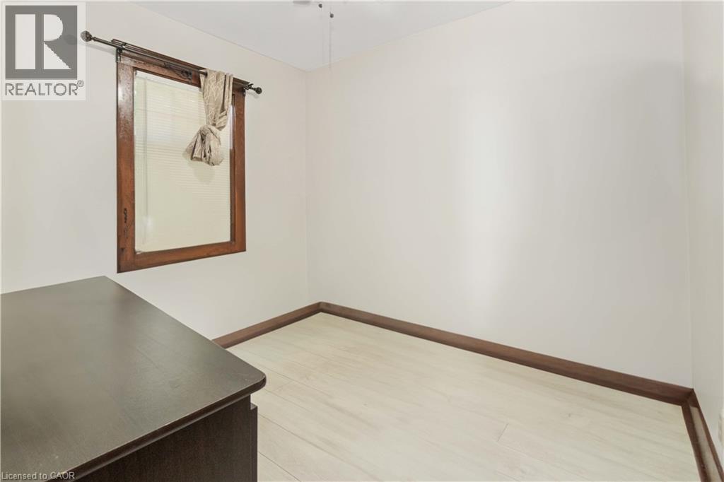 Room featuring light wood-finish flooring, white walls, and dark wood baseboards - 151 Louisa Street, Kitchener, ON - Indoor Photo Showing Other Room