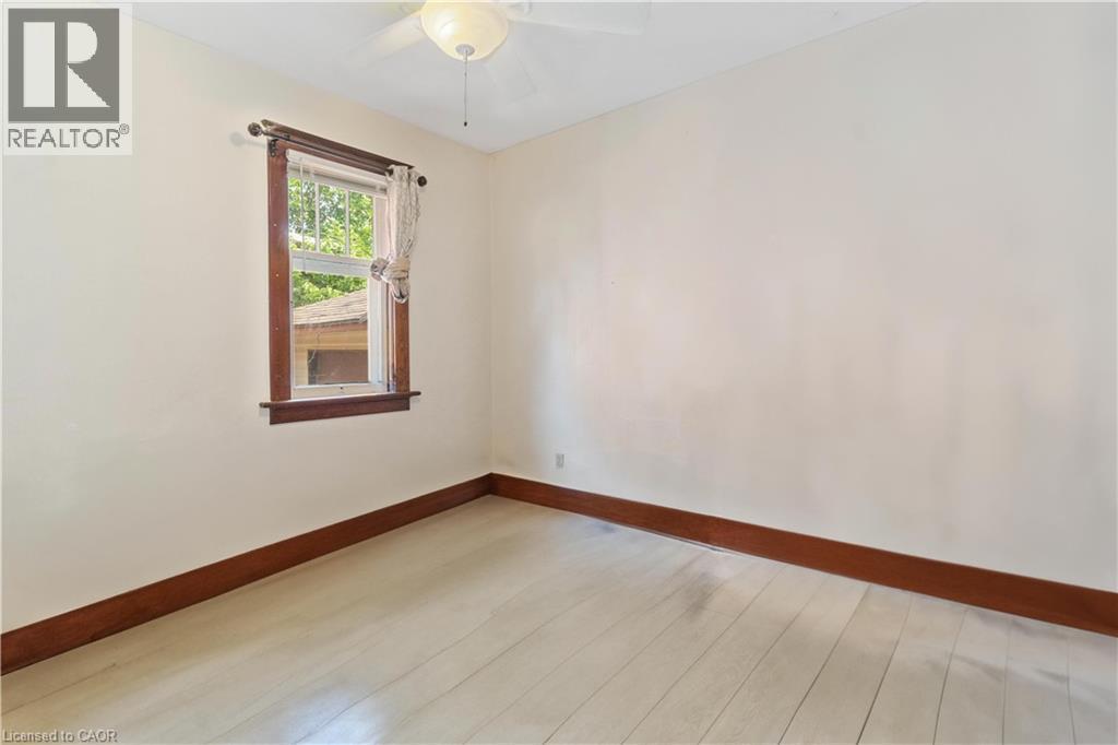 Room featuring light-toned wood-finish flooring, white walls, and dark wood trim - 151 Louisa Street, Kitchener, ON - Indoor Photo Showing Other Room