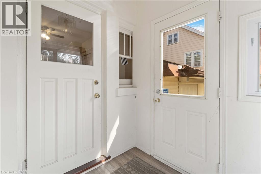 Two white paneled doors with upper glass inserts - 151 Louisa Street, Kitchener, ON - Indoor Photo Showing Other Room