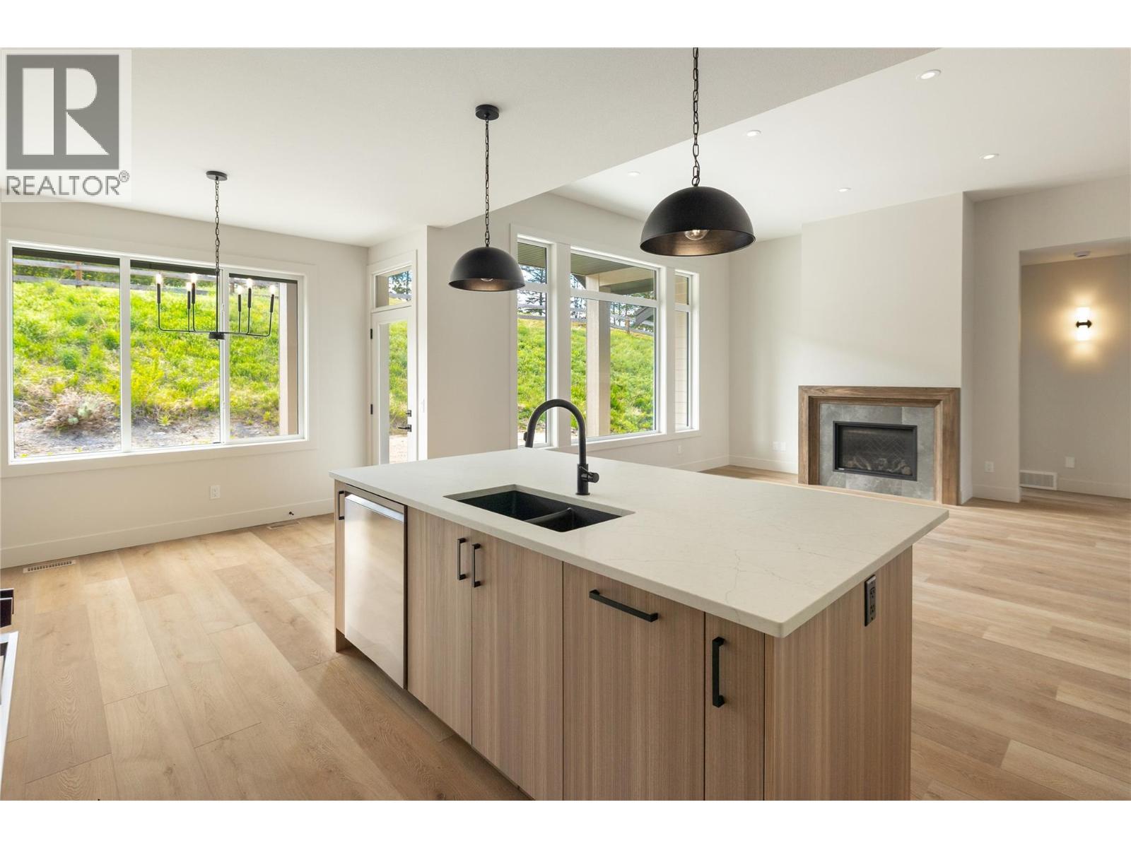 2125 Montenegro Drive, Kelowna, BC - Indoor Photo Showing Kitchen With Fireplace With Double Sink