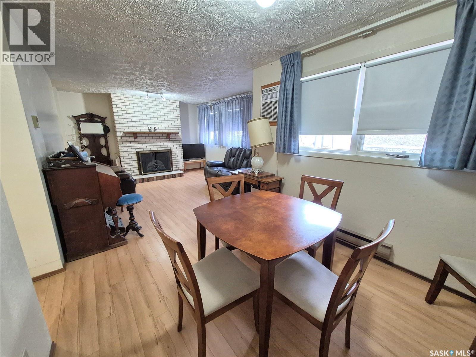 16 228 3Rd Street, Weyburn, SK - Indoor Photo Showing Dining Room With Fireplace