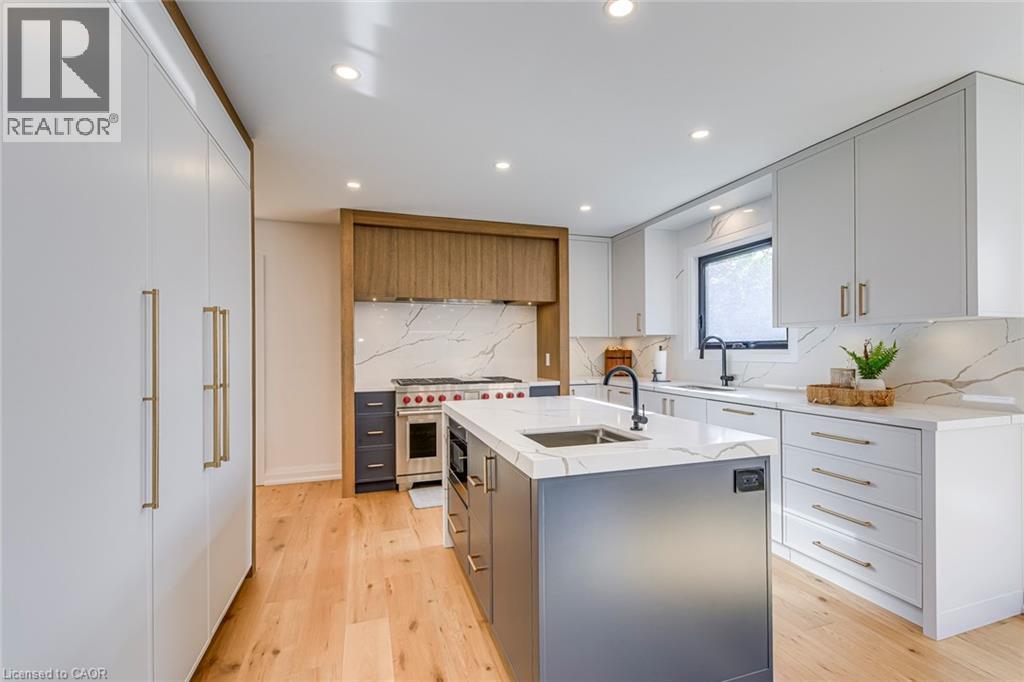 Modern kitchen featuring light wood-finish flooring and recessed lighting - 54 Deerview Avenue, Ancaster, ON - Indoor Photo Showing Kitchen