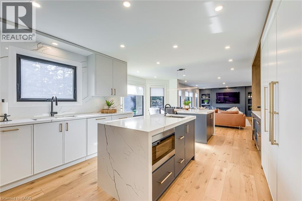 Modern kitchen featuring light wood-finish flooring and recessed lighting - 54 Deerview Avenue, Ancaster, ON - Indoor Photo Showing Kitchen With Upgraded Kitchen