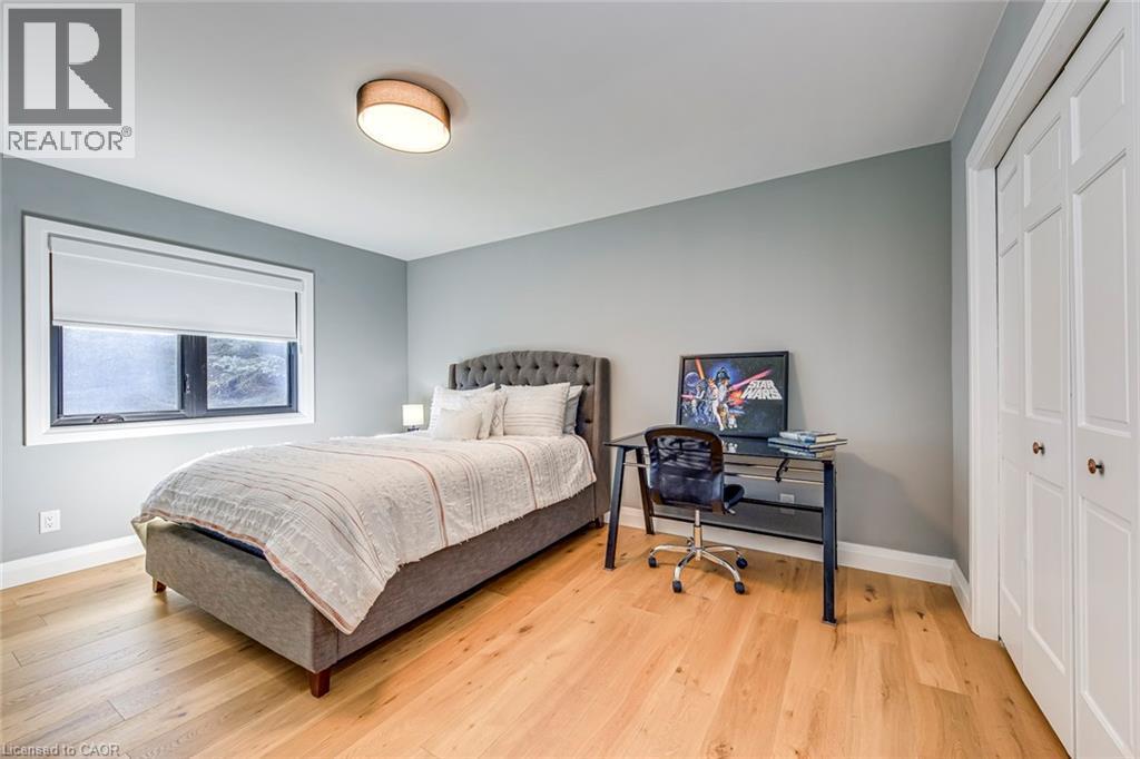 Bedroom featuring light-colored wood-finish flooring and a neutral wall color - 54 Deerview Avenue, Ancaster, ON - Indoor Photo Showing Bedroom