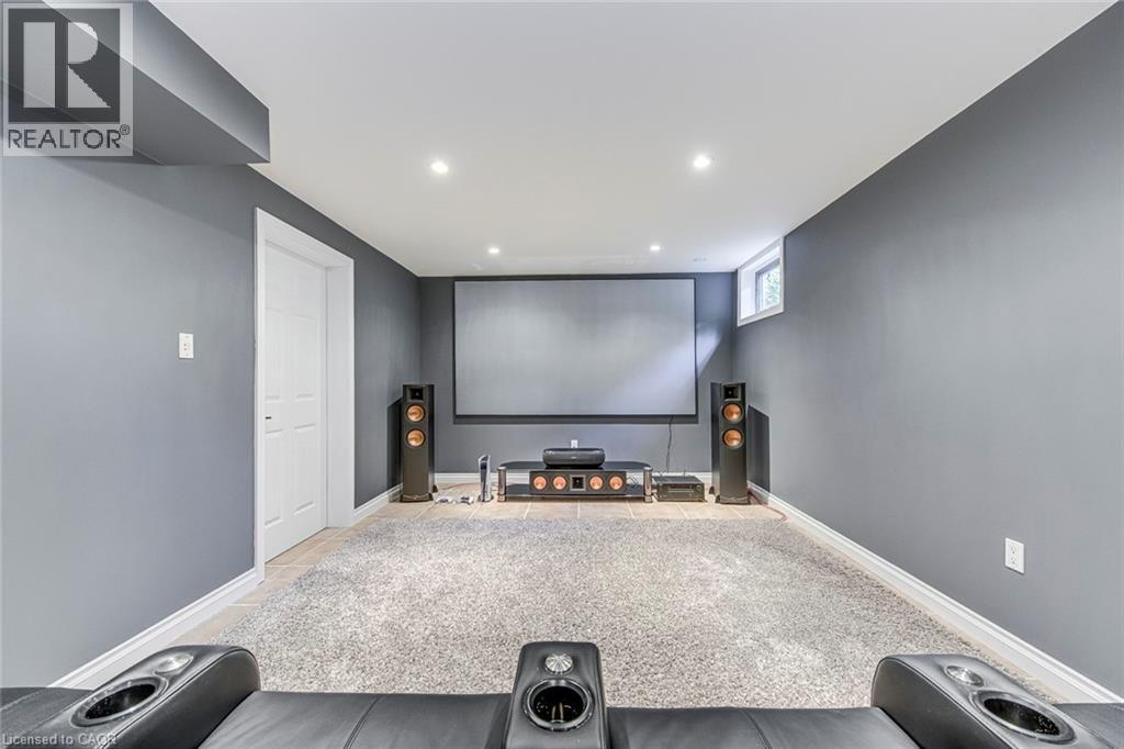 Dedicated media room featuring a large projection screen, recessed lighting, a high ceiling, and a high window - 54 Deerview Avenue, Ancaster, ON - Indoor Photo Showing Other Room