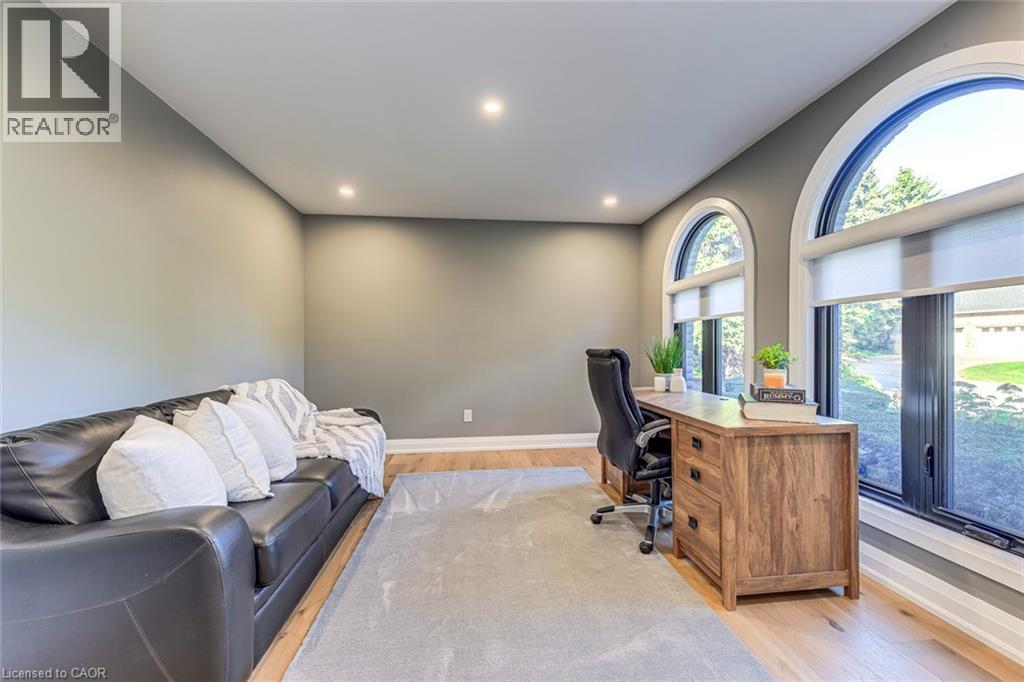 Room featuring arched windows, recessed lighting, wood-finish flooring, and neutral wall tones - 54 Deerview Avenue, Ancaster, ON - Indoor Photo Showing Office