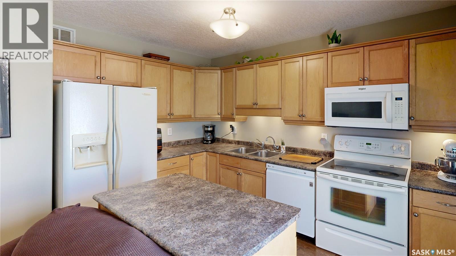 2 22 Qu'Appelle Crescent, Balgonie, SK - Indoor Photo Showing Kitchen With Double Sink