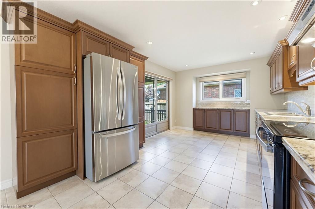 Kitchen featuring light-toned tile flooring, recessed lighting, and a stainless steel refrigerator - 6 General Street, Brantford, ON - Indoor Photo Showing Kitchen