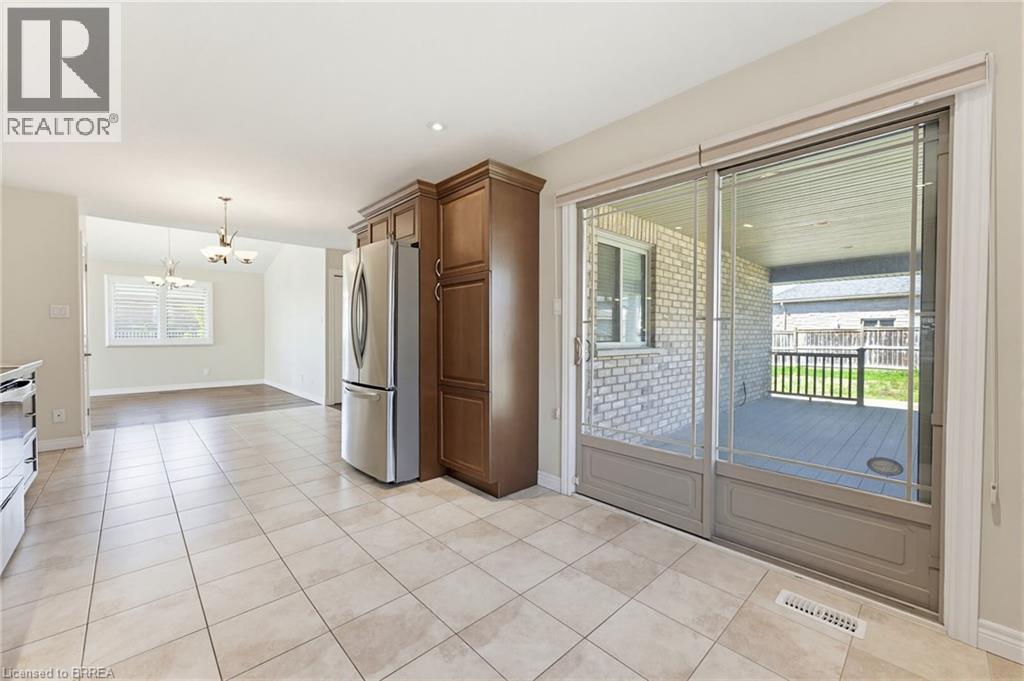 Kitchen with square tile flooring, stainless steel refrigerator, and dark wood cabinetry - 6 General Street, Brantford, ON - Indoor Photo Showing Other Room