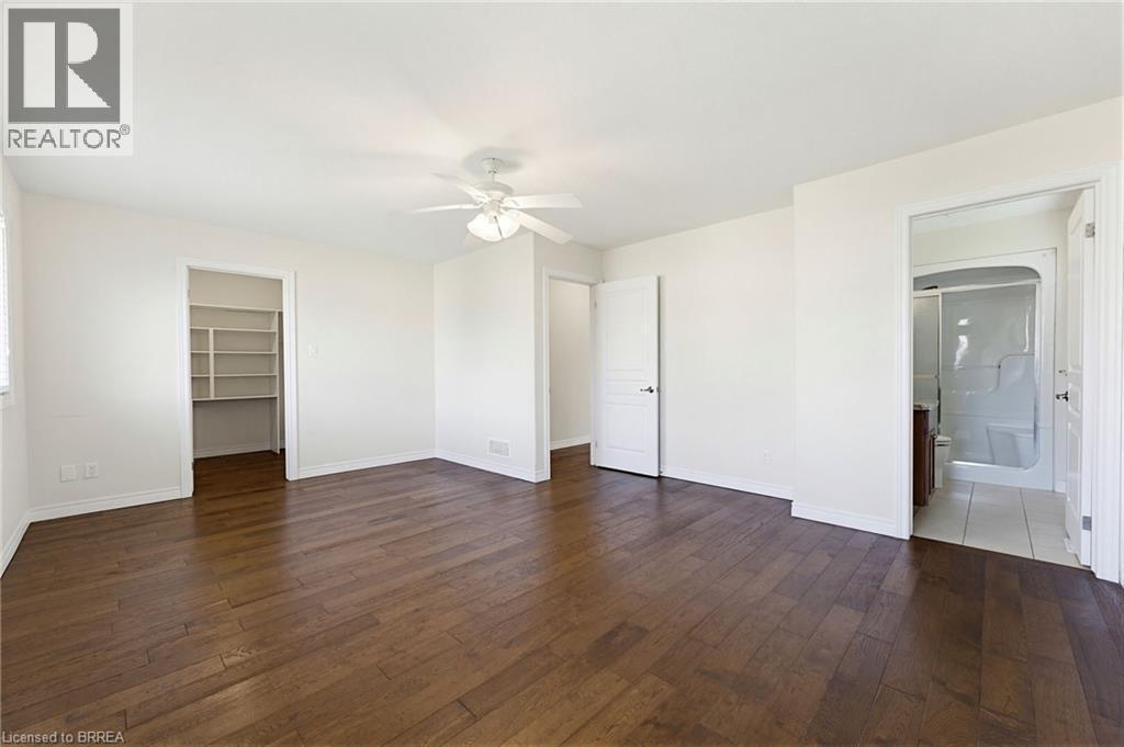 Spacious room featuring wood-finish flooring and bright white walls - 6 General Street, Brantford, ON - Indoor Photo Showing Other Room