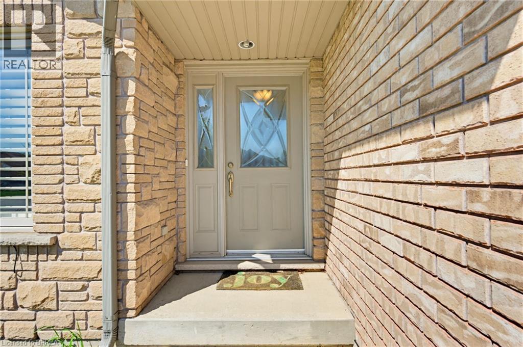 Entryway featuring a beige door with decorative glass inserts, a matching sidelight, and a recessed ceiling light - 6 General Street, Brantford, ON - Outdoor With Exterior