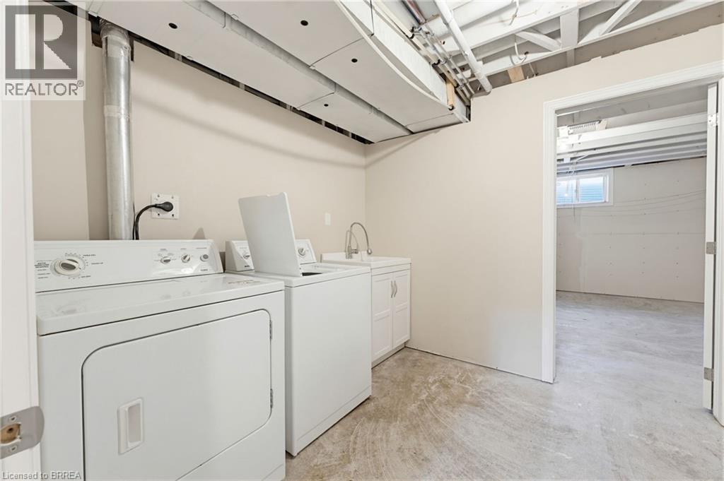 Dedicated laundry area featuring a utility sink with white cabinetry - 6 General Street, Brantford, ON - Indoor Photo Showing Laundry Room