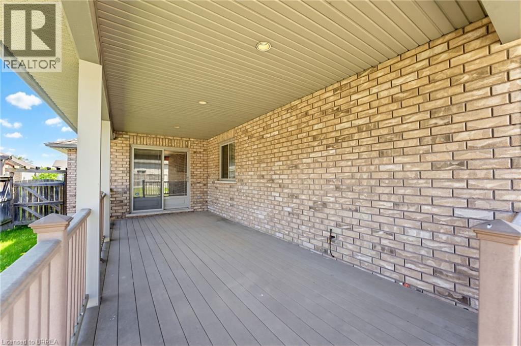 Expansive covered porch featuring composite decking and a brick exterior wall - 6 General Street, Brantford, ON - Outdoor With Deck Patio Veranda With Exterior