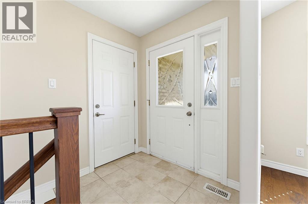Entryway featuring a white door with decorative glass inserts, a coordinating sidelight, and a second paneled door - 6 General Street, Brantford, ON - Indoor Photo Showing Other Room