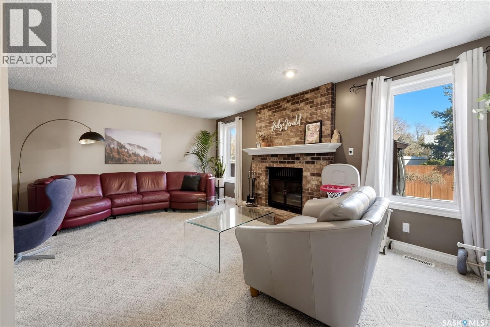 2947 More Crescent E, Regina, SK - Indoor Photo Showing Living Room With Fireplace