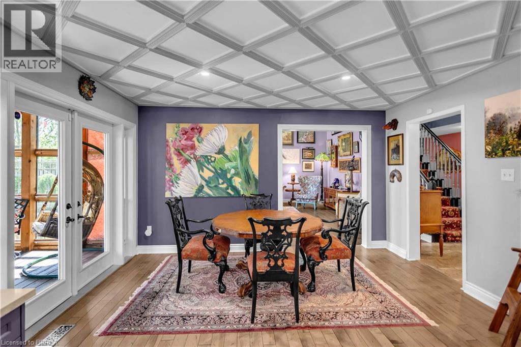 Hardwood flooring throughout this room featuring a coffered ceiling with recessed lighting - 69 Hunter Way, Brantford, ON - Indoor Photo Showing Dining Room