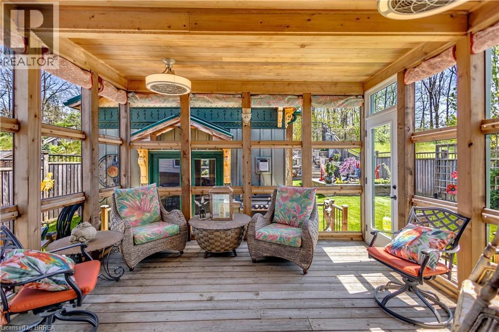 Enclosed wooden porch with a natural wood ceiling, wood-finish flooring, and exposed wood beams - 69 Hunter Way, Brantford, ON - Outdoor With Deck Patio Veranda