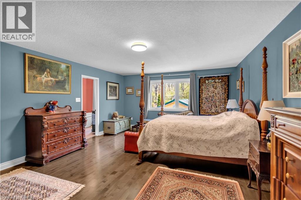 Spacious room featuring wood-finish flooring, light blue walls, and a recessed ceiling light - 69 Hunter Way, Brantford, ON - Indoor Photo Showing Bedroom