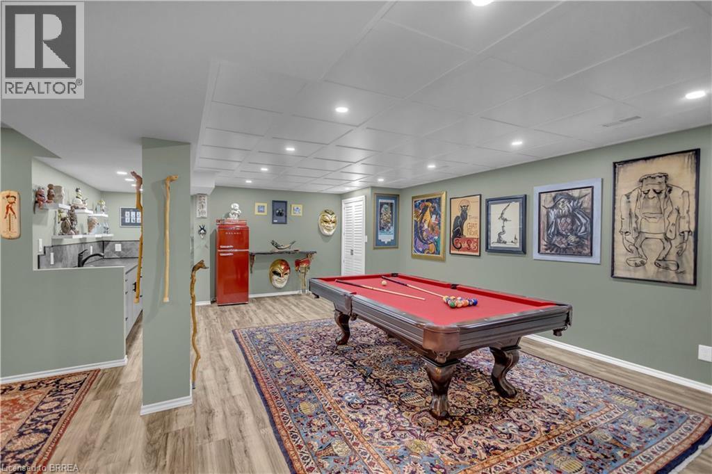 Recreation space featuring a billiard table with red felt, wood-finish flooring, recessed lighting, and a drop panel ceiling - 69 Hunter Way, Brantford, ON - Indoor Photo Showing Other Room