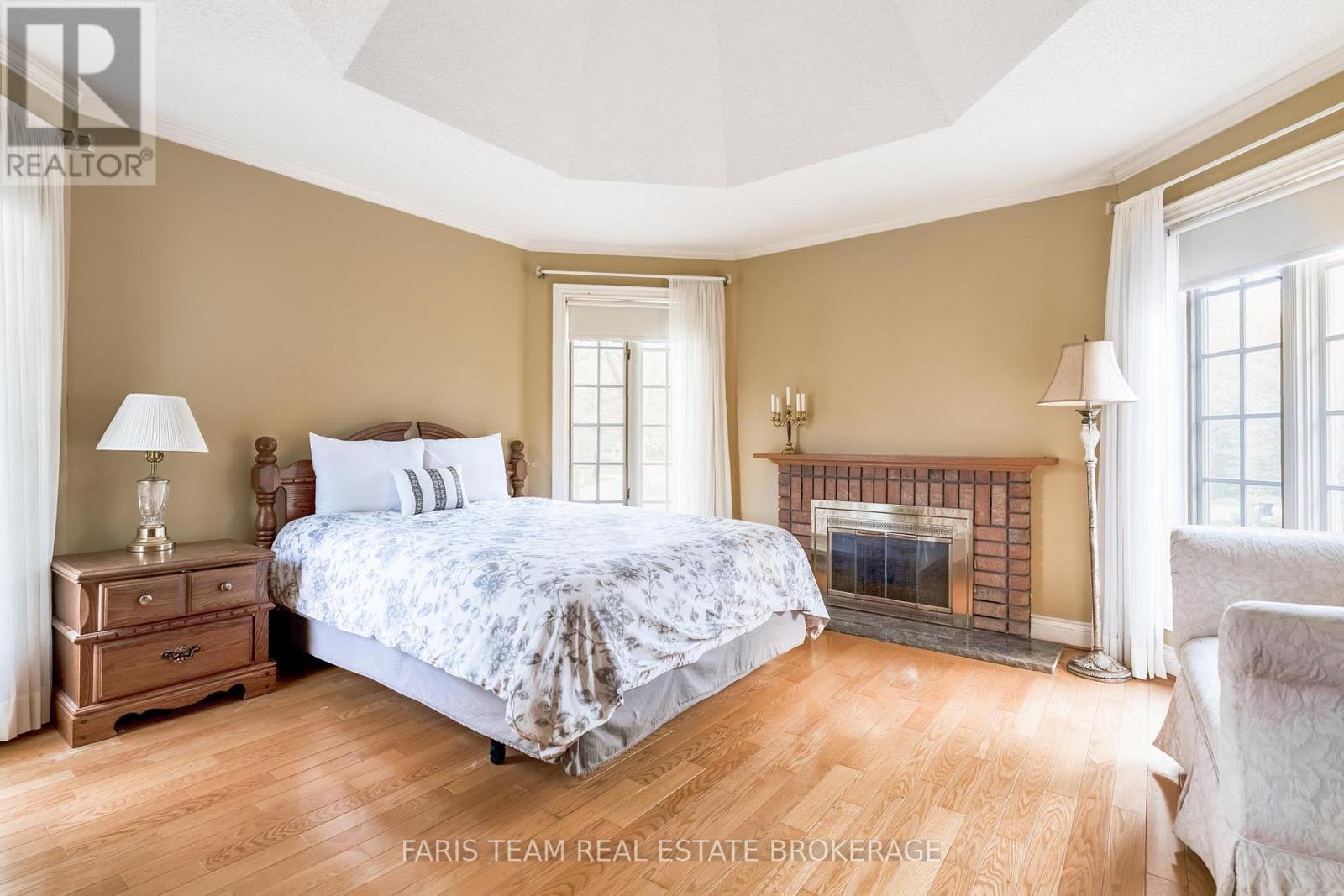 4 Mills Circle, Springwater, ON - Indoor Photo Showing Bedroom With Fireplace