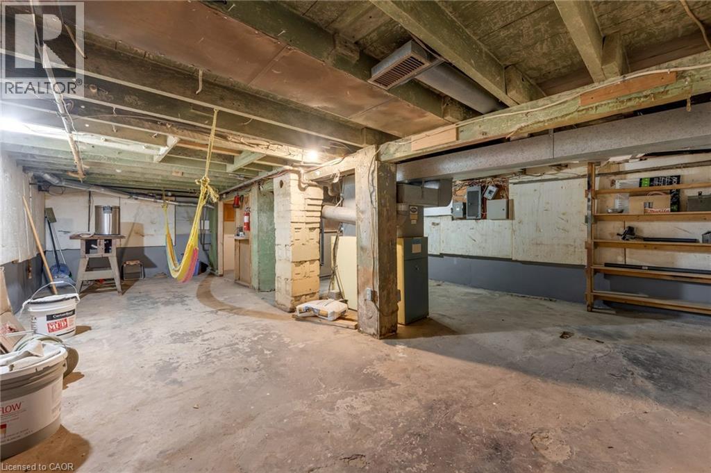 Unfinished basement with concrete flooring, exposed joists, and visible structural beams - 168 Britannia Avenue, Hamilton, ON - Indoor Photo Showing Basement