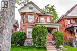 Red brick exterior with stone foundation detailing -