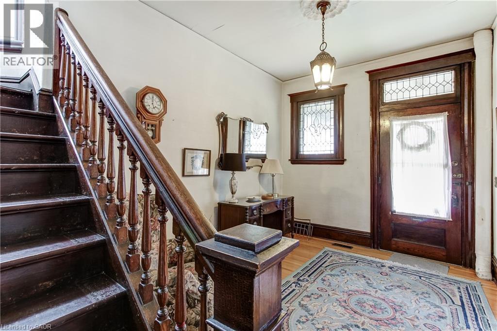 Wood-finish staircase with ornate balusters - 18 Fairleigh Crescent, Hamilton, ON - Indoor Photo Showing Other Room