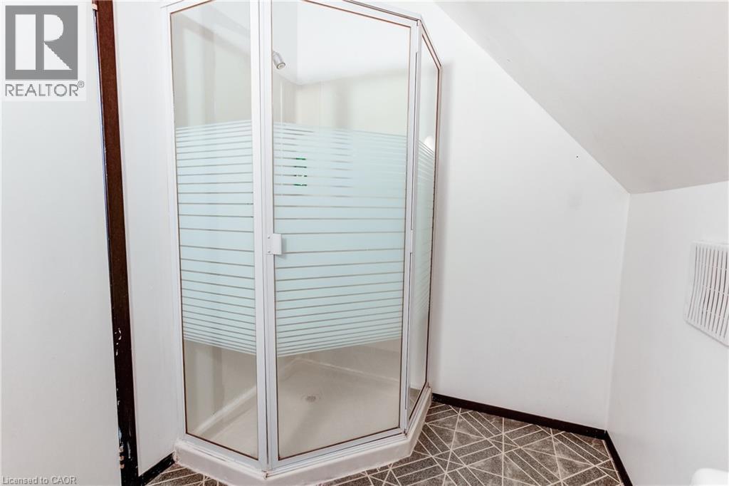 Corner shower enclosure featuring clear and frosted glass panels, an overhead shower fixture, and a white shower pan - 18 Fairleigh Crescent, Hamilton, ON - Indoor Photo Showing Bathroom
