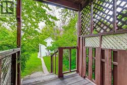 Covered porch with wood-finish flooring and lattice panels -