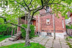Brick exterior featuring a multi-level deck with wood stairs and lattice screening -