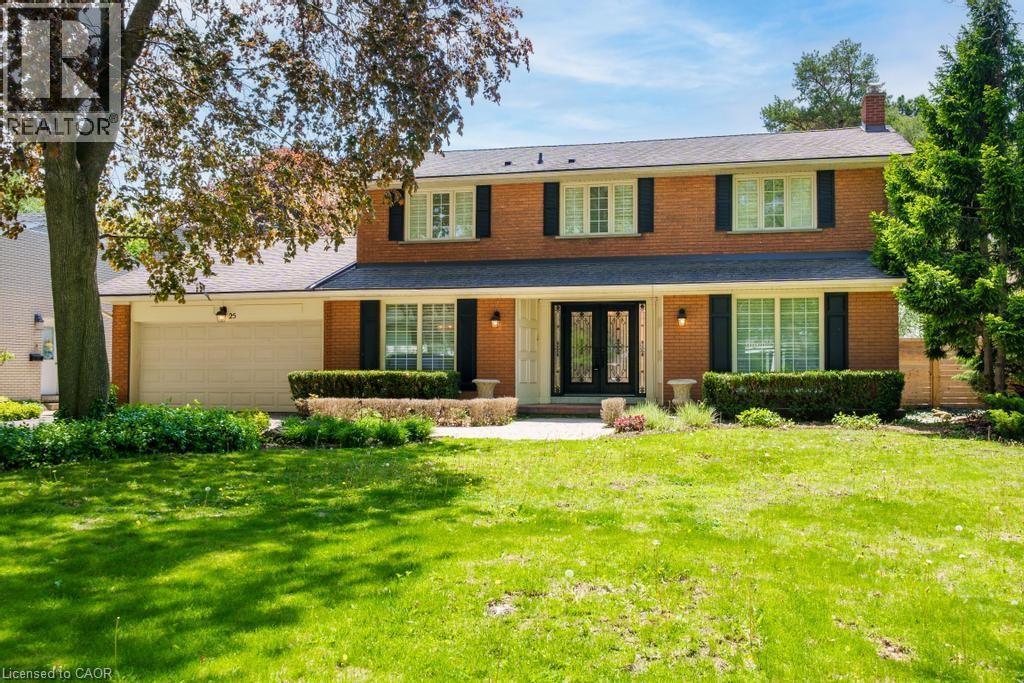 Brick-front residence featuring a double-door entry, a two-car garage, and established landscaping - 25 Braemar Place, Hamilton, ON - Outdoor With Facade