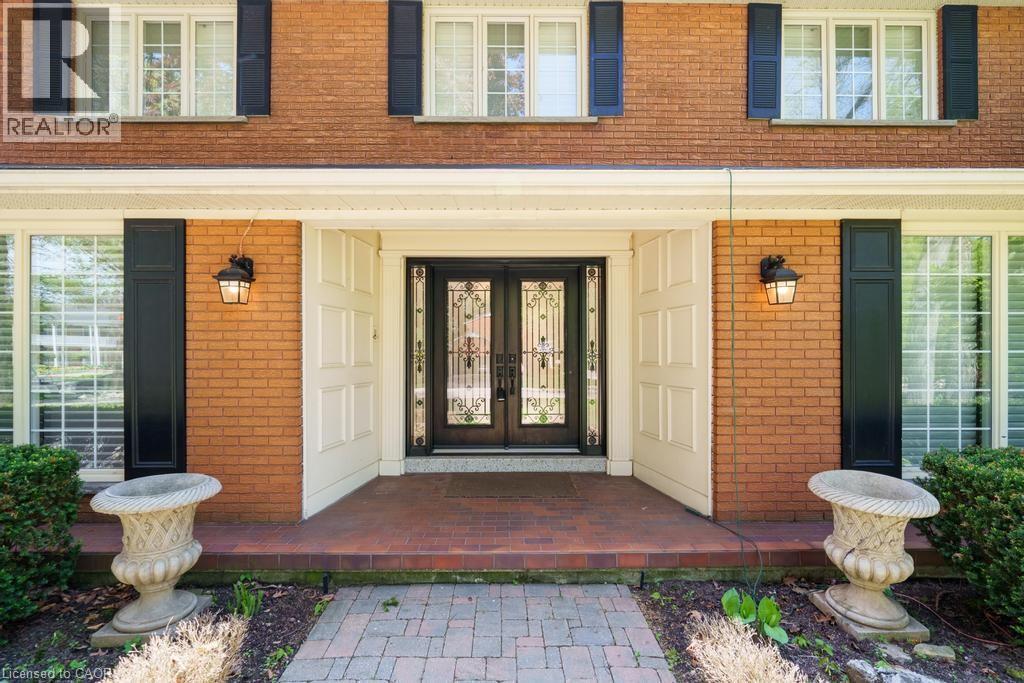 Brick facade with black shutters and a covered entry - 25 Braemar Place, Hamilton, ON - Outdoor With Exterior