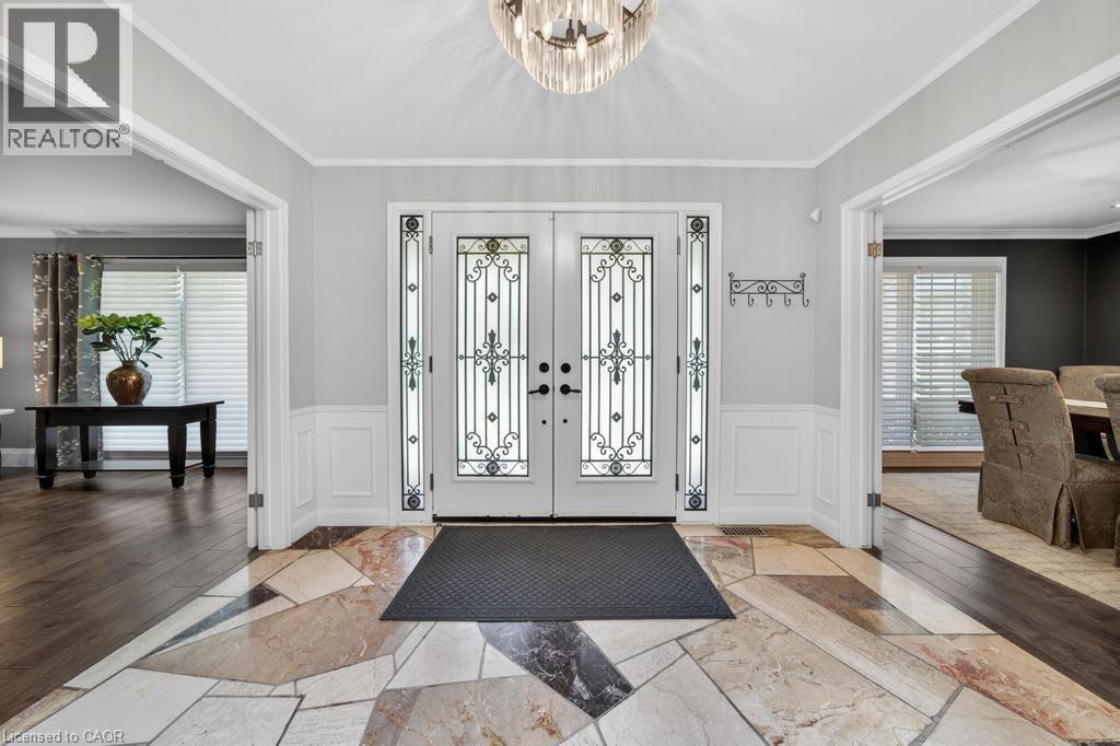 Grand entry featuring double doors with decorative ironwork and sidelights - 25 Braemar Place, Hamilton, ON - Indoor Photo Showing Other Room