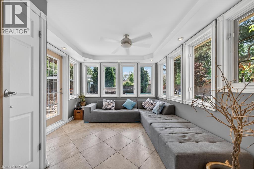 Sunroom featuring a full wall of windows, recessed lighting, a ceiling fan, and tile flooring - 25 Braemar Place, Hamilton, ON - Indoor Photo Showing Other Room