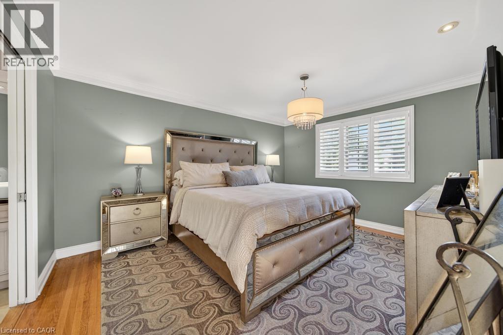Room featuring a window with plantation shutters, crown molding, and wood-finish flooring - 25 Braemar Place, Hamilton, ON - Indoor Photo Showing Bedroom