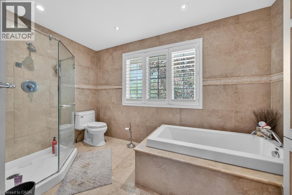 Contemporary bathroom featuring a built-in soaking tub and a glass-enclosed shower - 25 Braemar Place, Hamilton, ON - Indoor Photo Showing Bathroom