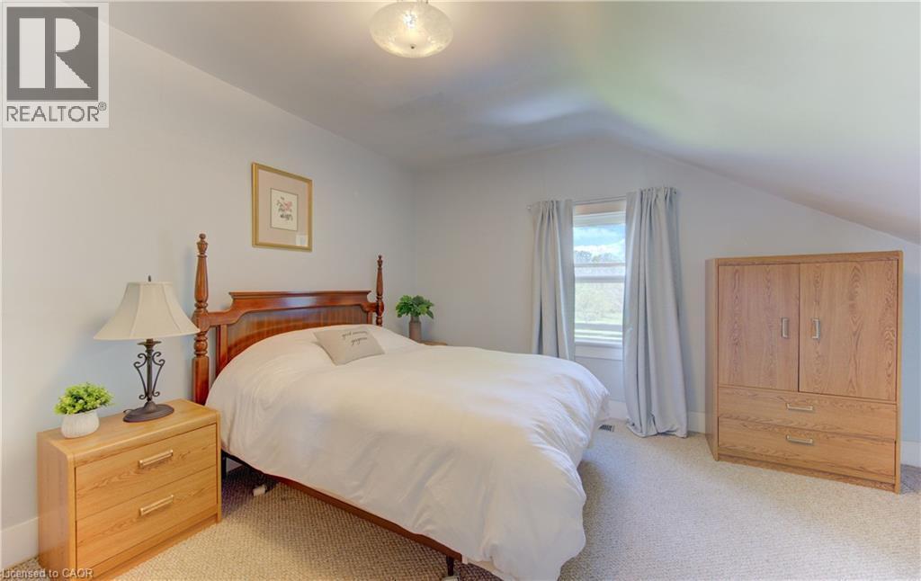 Carpeted room with a pitched ceiling and neutral wall tones - 1463 Kossuth Road, Cambridge, ON - Indoor Photo Showing Bedroom