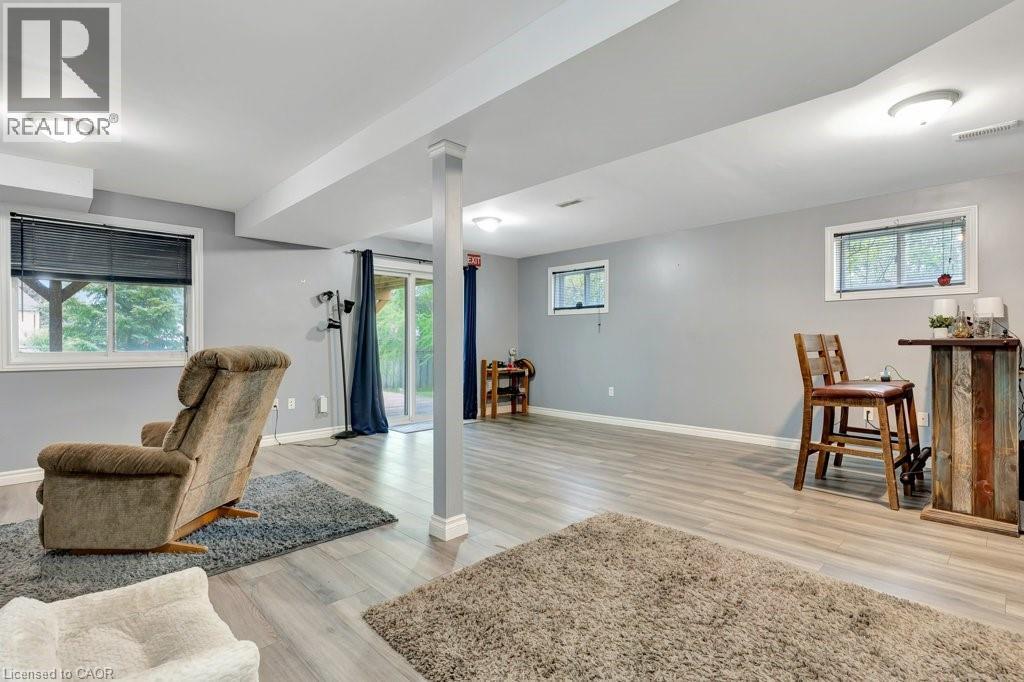 Finished lower level featuring light gray walls and wood-finish flooring - 49 Small Court, Cambridge, ON - Indoor