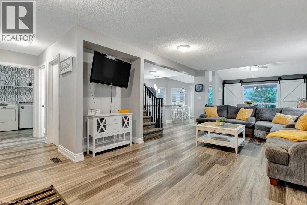Spacious interior with wood-finish flooring extending throughout - 49 Small Court, Cambridge, ON - Indoor Photo Showing Living Room