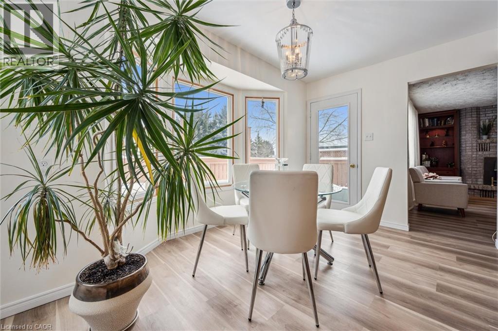 Dining area featuring light wood-finish flooring and a bay window - 488 Heather Hill Place, Waterloo, ON - Indoor Photo Showing Dining Room