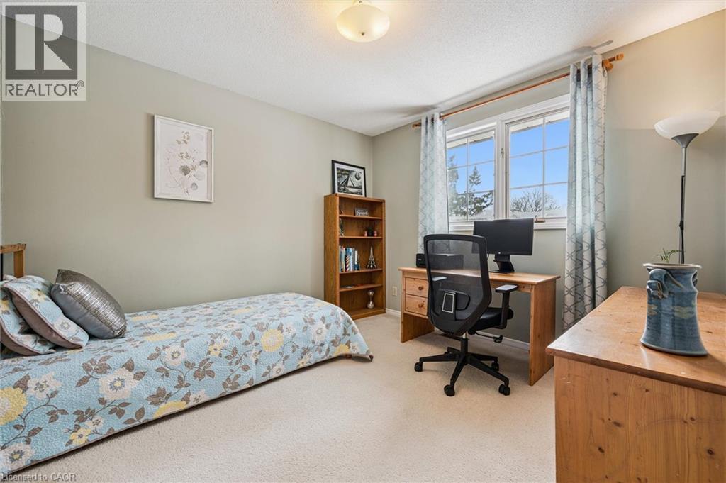 Wall-to-wall carpeting and neutral wall tones create a versatile interior - 488 Heather Hill Place, Waterloo, ON - Indoor Photo Showing Bedroom